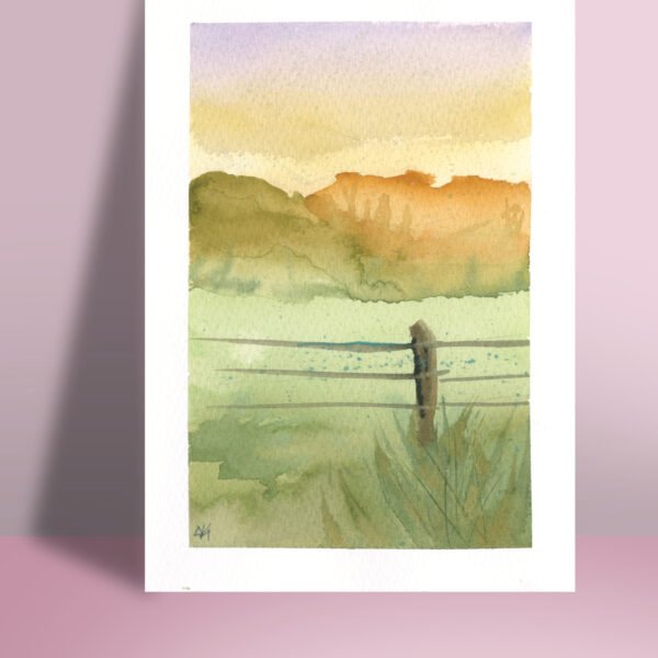 A 5x7" watercolor print featuring a tranquil mountainscape with a pastel purple and yellow sky, and a rustic fence as the focal point.
