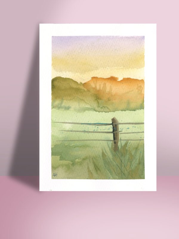 A 5x7" watercolor print featuring a tranquil mountainscape with a pastel purple and yellow sky, and a rustic fence as the focal point.