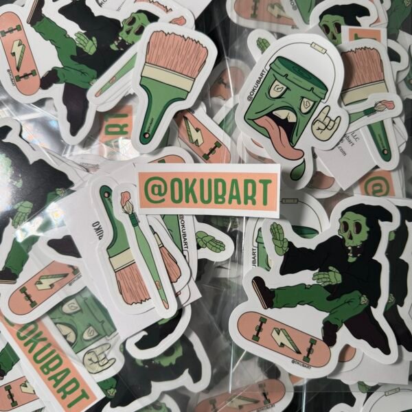 Five-piece vinyl sticker pack featuring bold, cartoon-style artwork: a five-gallon paint bucket with a face, two expressive paintbrushes (thin and thick), a dynamic skeleton or grim reaper doing a kickflip on a skateboard, and an @okubart artist tag. Designed in a colorful, street art-inspired style with bold outlines and graphic flair.